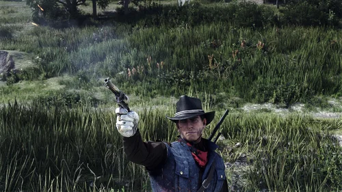 Could contain: outdoor, plant, grass, person, weapon, clothing, tree, sun hat, cowboy hat, shotgun, hat, field